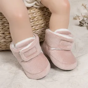 Detailed view of pink corduroy baby winter boots with warm fleece lining and velcro strap