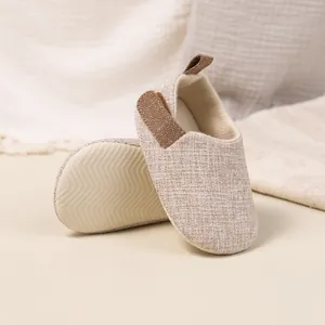 Close-up of non-slip textured sole and breathable linen upper on baby walking shoes