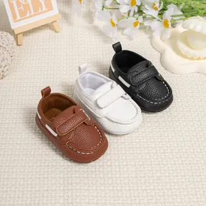 Infant moccasin walking shoes in brown, white and black with hook-and-loop closure