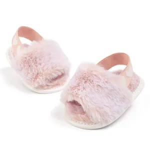 Macro shot of pink faux fur baby shoes featuring elastic heel straps with heart patterns