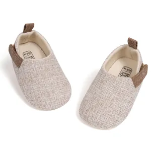 Detail of baby walking shoes showing soft fabric texture and inner size label
