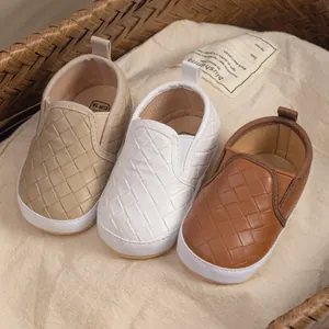 Detail of baby walking shoes showing woven toe and soft sole in multiple colors