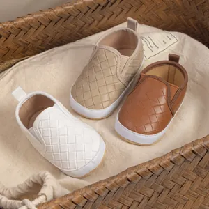 Detailed view of woven slip-on baby shoes in white, beige, and brown with soft anti-slip soles