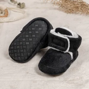 Detail of baby winter boots with corduroy fabric, warm faux fleece lining and non-slip sole