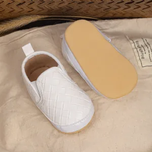 Detail view of baby walking shoes with white woven texture and anti-slip soft soles