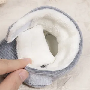 Detailed close-up showing thick white faux fur lining and corduroy texture on baby winter boots