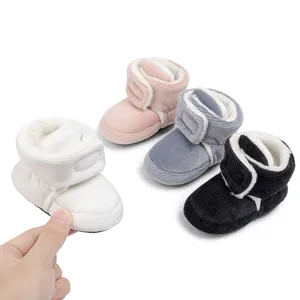 Detail of baby winter boots with corduroy texture and warm plush lining and velcro strap