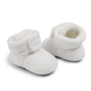 Detail view of baby boots showing soft white corduroy fabric and warm plush lining