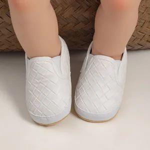 Detail of white woven slip-on baby shoes with flexible elastic collar and soft rubber sole