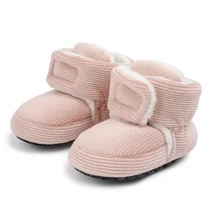 Detail of pink corduroy baby boots showing soft fleece lining and velcro closure