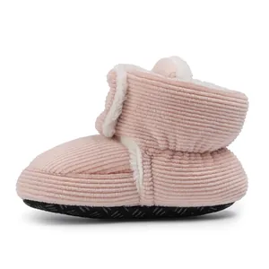 Detail view of pink corduroy baby boots with warm faux fur lining and non-slip soft soles