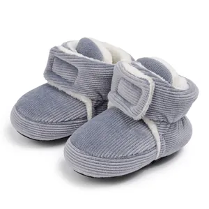 Detail of blue corduroy baby snow boots with warm white fleece lining and Velcro strap