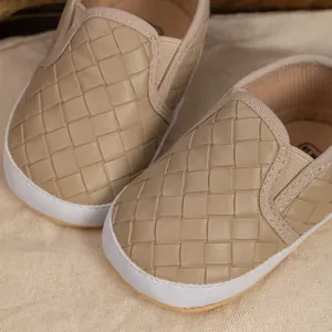 Macro shot of khaki woven leather baby walking shoes with elastic side bands