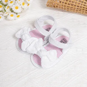 White baby girl bow sandals with breathable fabric and velcro strap for first walkers