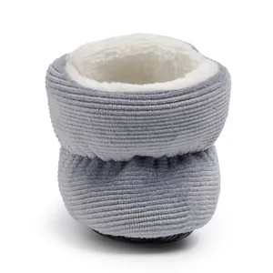 Detailed macro view of gray corduroy baby bootie with thick plush faux fur lining