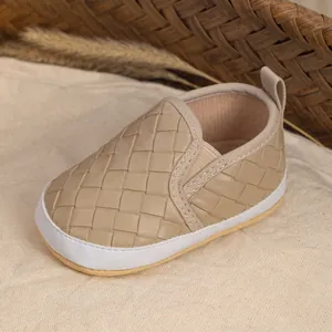 Detail of baby walking shoes with woven leather texture and soft anti-slip soles