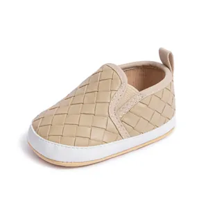 Detailed view of camel faux leather woven texture and elastic collar on baby walking shoes
