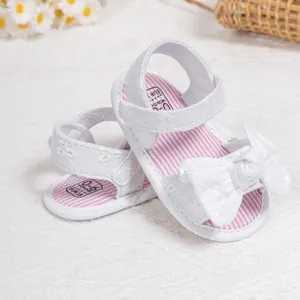 Close-up of baby sandals with bow and size marking for zero to six months old