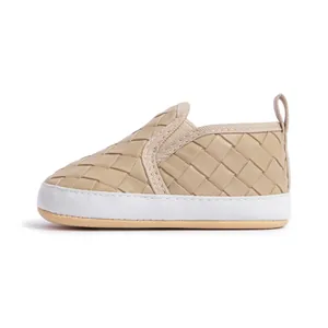 Detailed side view of khaki slip-on baby walking shoes with woven texture and white sole
