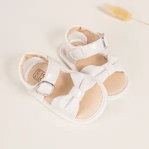 Detail of white baby sandal showing size 6-12 months and adjustable metal buckle