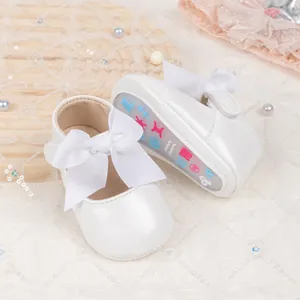 Detail of baby princess shoes featuring large bows and colorful zodiac rubber soles