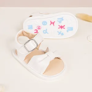 White baby sandals with decorative bow and colorful constellation printed rubber sole
