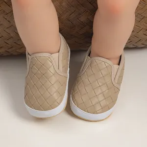 Top view of baby slip-on walking shoes featuring khaki woven leather and elastic straps