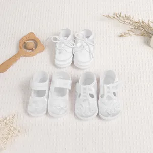 Three pairs of white lace baby walking shoes with satin finish and heart embroidery