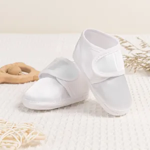White satin baby shoes with soft soles and lace details for infants and toddlers