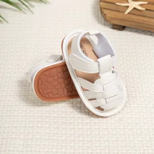 Close-up of baby walking sandals with non-slip rubber soles and velcro straps