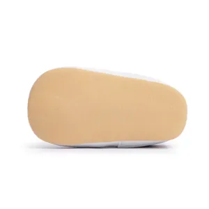 Detailed bottom view of slip-on baby shoes with non-slip soft soles and woven texture