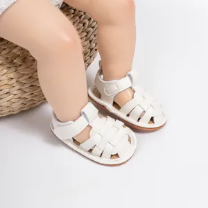 Macro shot of white woven baby sandals with leather texture and secure velcro strap closure