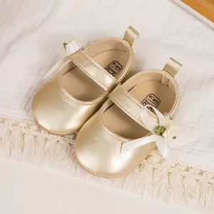 Champagne gold baby Mary Jane shoes with silk bow and floral detail on textured fabric