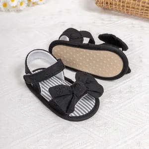 Detail of baby bow sandals with anti-slip dotted soft soles and velcro strap closure
