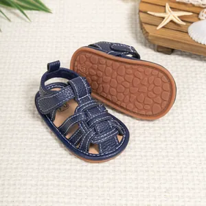 Detail of navy baby sandals showing breathable woven straps and anti-slip rubber soles
