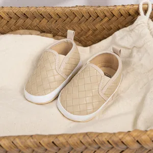 Woven beige faux leather slip-on baby walking shoes with soft white flat soles