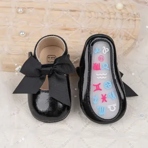 Close-up of baby princess shoes with black bow and colorful constellation non-slip soles