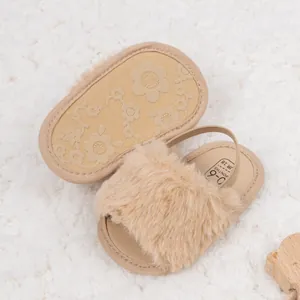 Détail des sandales bébé en peluche avec semelles souples antidérapantes à fleurs