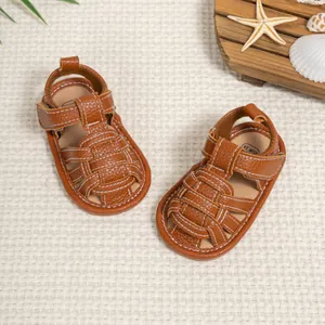 Brown woven baby sandals with adjustable velcro straps and non-slip sole for summer