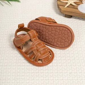 Close-up of brown baby sandals with non-slip rubber soles and secure velcro straps
