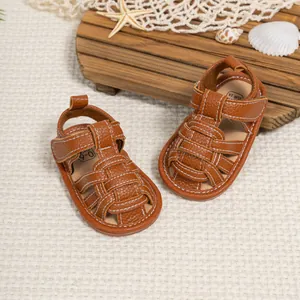 Brown infant leather sandals with white stitching and woven hollow design for summer