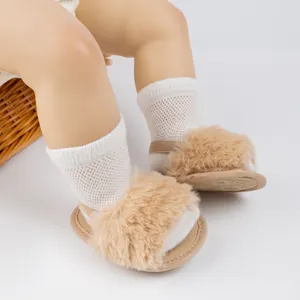 Gros plan de sandales bébé kaki en fourrure avec bride arrière et chaussettes résille