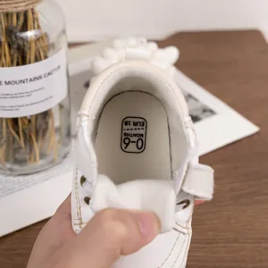 Macro detail of baby walking shoe interior showing size 18 and soft leather texture