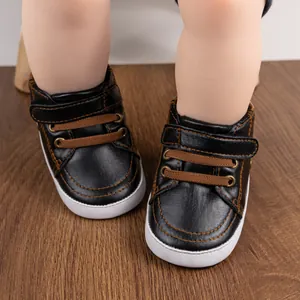 Detail of baby walking shoes with soft rubber soles and faux leather velcro closure