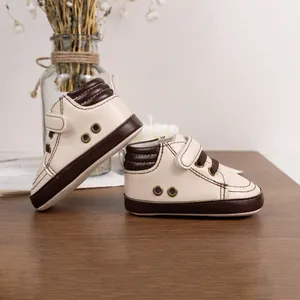 Detailed view of baby high-top sneakers with retro leather patch and velcro strap