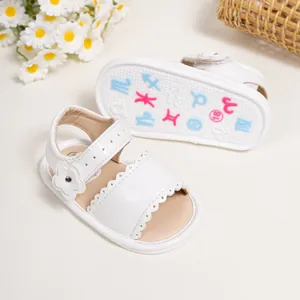 Detail view of baby girl sandals featuring floral accents and non-slip rubber sole