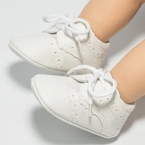 White brogue baby walking shoes with soft leather texture and lace-up design for infants