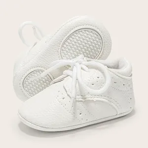 White soft sole baby walking shoes with textured leather and brogue punch details