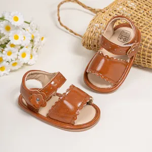 Close-up of brown baby sandals with flower detail and size text on soft inner sole