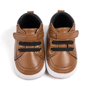 Macro shot of brown baby sneakers featuring velcro strap and soft white rubber sole